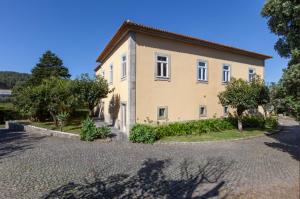 a large house with trees in front of it at Quinta S. Romao do Neiva in Castelo do Neiva