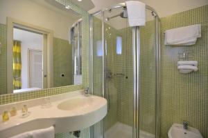 a bathroom with a sink and a shower at UNAHOTELS Club Hotel Ancora in Stintino