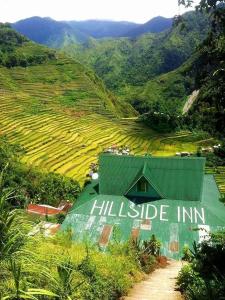 a green building with the hillside inn written on it at Batad Hillside Inn and Restaurant in Banaue