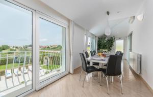 a dining room with a table and chairs and a large window at Luxury Villa Lavanda with Pool and Sauna in Kanfanar