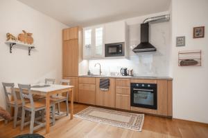a kitchen with a table and a stove top oven at Apartment with Balcony in Prague
