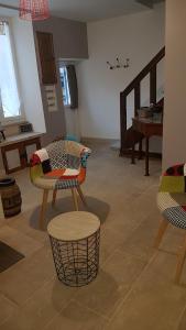 a living room with two chairs and a table at Gîte La P'tite Louise in Les Riceys