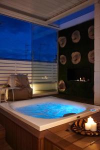 a jacuzzi tub in a room with a fireplace at Musae Relais & SPA in Polignano a Mare