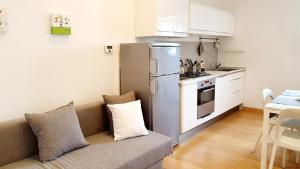 a living room with a couch and a kitchen at ALmare - Sea Front in Livorno