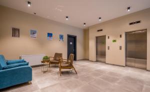 a living room with a blue couch and a table at New Gudauri, Loft 1, #114, Cosy Apartment -Gondola lift in Gudauri