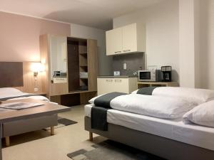 Postel nebo postele na pokoji v ubytování Hana Aparthotel