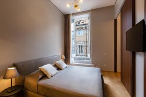 Voodi või voodid majutusasutuse Amazing Piazza Venezia Suites toas