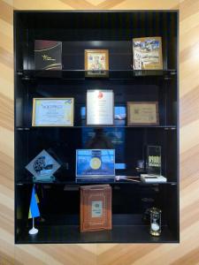 a collection of books on a wooden shelf at Sribni Leleky Hotel & Spa in Lutsk