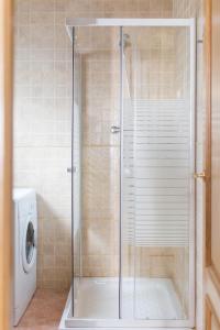 a shower in a bathroom with a washing machine at Oceanográfico Apartments in Valencia