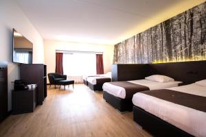 Postel nebo postele na pokoji v ubytování Bastion Hotel Apeldoorn Het Loo