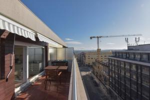 Un balcón con una mesa y vista a una ciudad. en Alexandre Herculano Oporto Residence I II & III, en Oporto