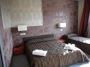Postel nebo postele na pokoji v ubytování Residence San Marino