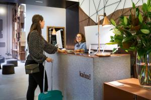 a woman standing at a counter in an office at One Shot Tabakalera House in San Sebastián