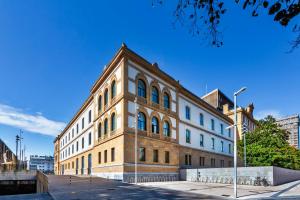 a large brick building on a city street at One Shot Tabakalera House in Donostia-San Sebastián