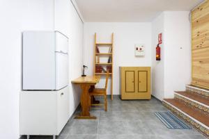 a kitchen with a refrigerator and a wooden table at Estudio La Hornera in La Laguna