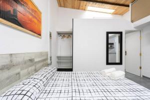 a white room with a large bed in it at Estudio La Hornera in La Laguna