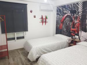 a room with two beds and a bicycle on the wall at Mezquita- Elite, Parking, Wifi in Córdoba