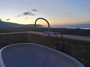 a bath tub with a faucet and a sink at Elafonisi Villa above the Beach in Elafonisi