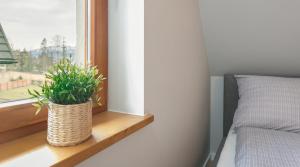 Postel nebo postele na pokoji v ubytování TWOJA CHATA Apartamenty pod niebem zarezerwuj na podhalami pl