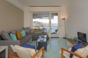a living room with a couch and a tv at Casa Linda - Incredible View, Pool & Tennis in Rapallo
