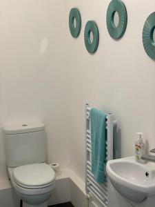 a white bathroom with a toilet and a sink at Carvetii - Edward House B - 2 Dbl bed 1st floor flat in Dunfermline