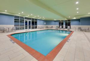 a large pool with blue water in a hotel room at Holiday Inn Express & Suites - Dallas NW HWY - Love Field by IHG in Dallas