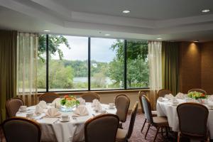 a conference room with tables and chairs and a large window at Holiday Inn Austin -Town Lake, an IHG Hotel in Austin