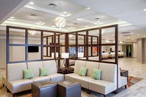 a waiting room with two white chairs and windows at Holiday Inn Austin -Town Lake, an IHG Hotel in Austin