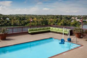 a pool on the roof of a hotel with a couch at Holiday Inn Austin -Town Lake, an IHG Hotel in Austin