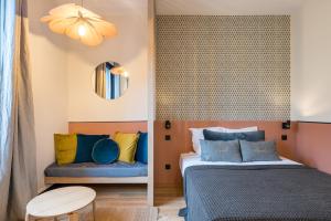 a bedroom with two beds and a chair at HONORÊ - SUITE ARBRE SEC in Lyon