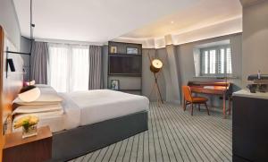 a hotel room with a bed and a desk at Andaz London Liverpool Street - a Concept by Hyatt in London