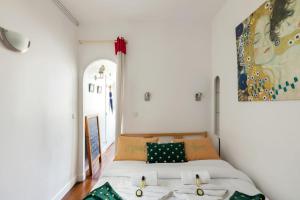 a bedroom with a bed and a painting on the wall at GuestReady - Quaint Apartment with Rooftop views of Montmarte in Paris