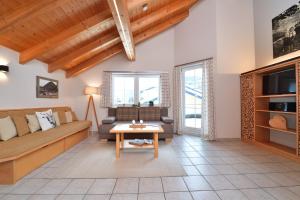 a living room with a couch and a table at Haus im Wäldle in Balderschwang