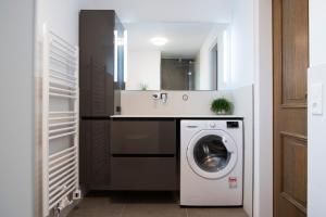 a bathroom with a washing machine and a sink at Gästehaus Wührer in Franking