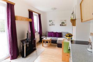 a kitchen and a living room with a couch at Wohnung am See in Steinbach am Attersee
