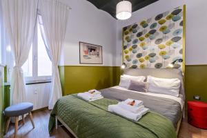 a bedroom with a bed with two towels on it at Rome As You Feel - Orti Trastevere Apartment in Rome