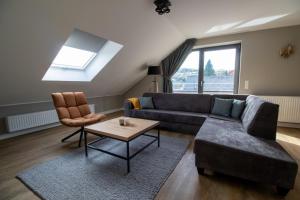 a living room with a couch and a table at UplandParcs Bergblick in Winterberg