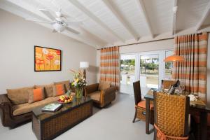 a living room filled with furniture and a large window at All Seasons Resort in Saint James