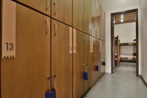 a row of wooden lockers in a hallway at Hostel Chocolatchê in Gramado