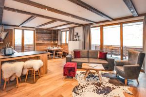 a living room with a couch and a table at LUX ALP CHALET am Arlberg in Warth am Arlberg