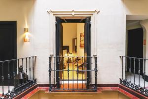 a staircase in a building with a gold door at Joya del Casco Boutique Hotel by Shiadu in Seville