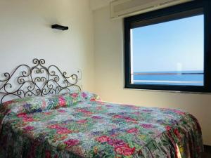 Postel nebo postele na pokoji v ubytování Appartamento Capo Mimosa