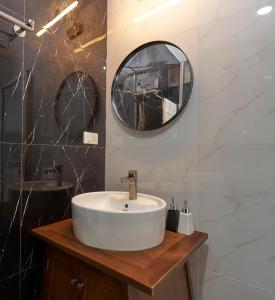 a bathroom with a sink and a mirror at Little Colmar - Homestay & Pottery Studio in Ha Long +46 photos