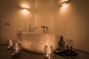 a bathroom with a tub with lights in it at Royal Palm Resort & Spa - Adults Only in Playa Jandia