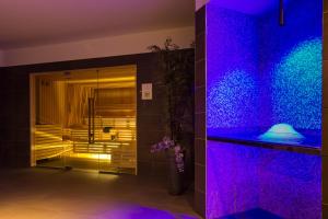 a bathroom with purple lights on the wall at Royal Palm Resort & Spa - Adults Only in Playa Jandia