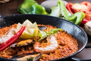 a pan of food with shrimp and rice and vegetables at Royal Palm Resort & Spa - Adults Only in Playa Jandia