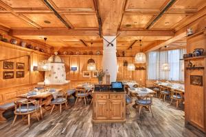 a restaurant with wooden walls and tables and chairs at Sunday Hotel Stuttgart Herrenberg in Herrenberg