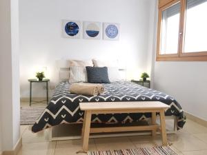 a bedroom with a bed with a black and white comforter at La Cornisa Villa by WaveProperties in Las Palmas de Gran Canaria