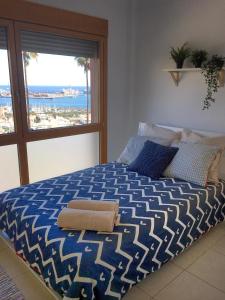 a bedroom with a bed with a view of the ocean at La Cornisa Villa by WaveProperties in Las Palmas de Gran Canaria