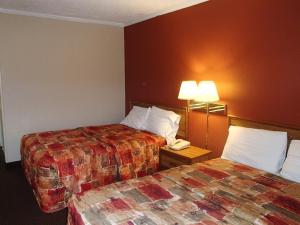 Giường trong phòng chung tại Sunrise Inn Lake Charles